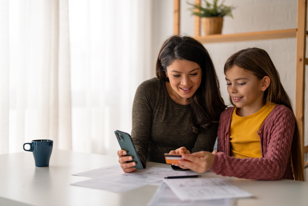 Mother and daughter looking at phone